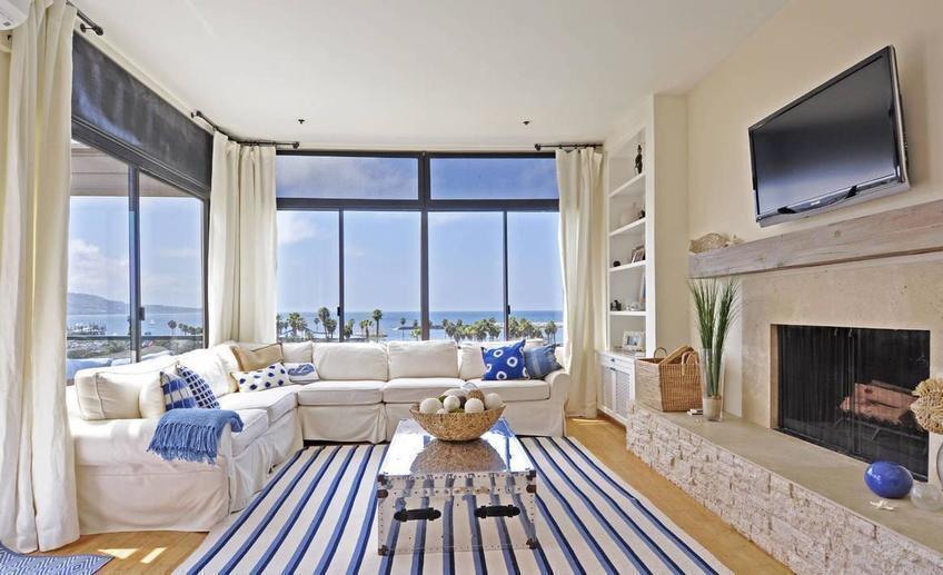 Stylish nautical living room interior decor with cool white and blue striped rug