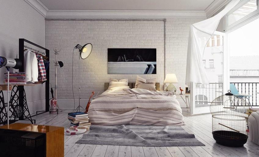 6 the awesome gorgeous loft style bedroom has a floor standing lamp hardwood flooring brick wall a clothes hanger rack a striped bed linen pile of books and a bird cage